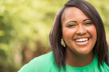 therapy-in-Brantford-image-African-American-woman-in green-top-smiling- happy-link-therapy-brantford