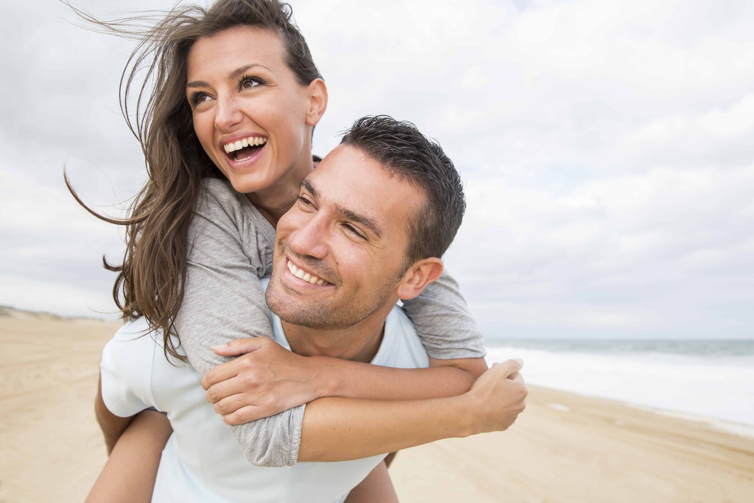 happy-couple-woman-embrace-man-on-beach-used-as-link-for-couples-counselling